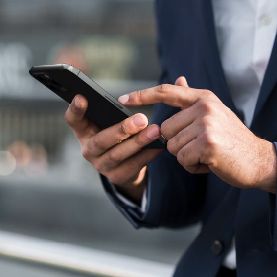 Businessman using smartphone for logistics management.